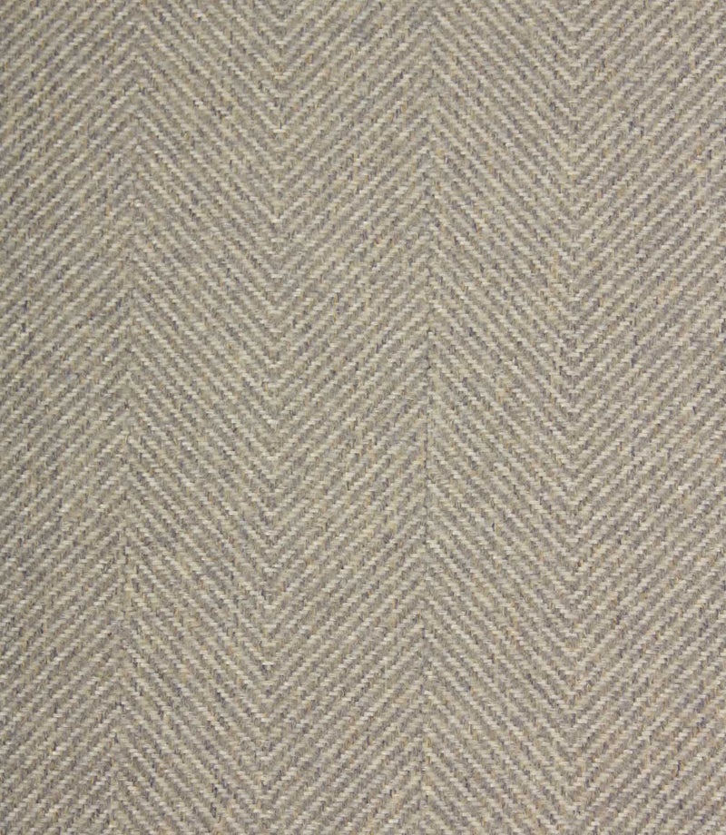 Textured fabric with a herringbone pattern in grey tones.