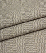 Close-up of grey fabric with a herringbone pattern