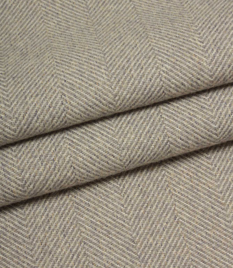 Close-up of grey fabric with a herringbone pattern