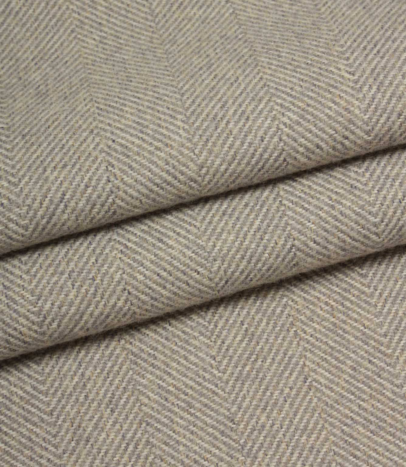 Close-up of grey fabric with a herringbone pattern