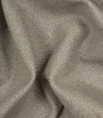 Close-up of grey fabric with a herringbone pattern