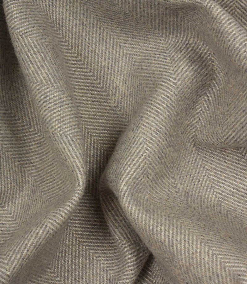 Close-up of grey fabric with a herringbone pattern