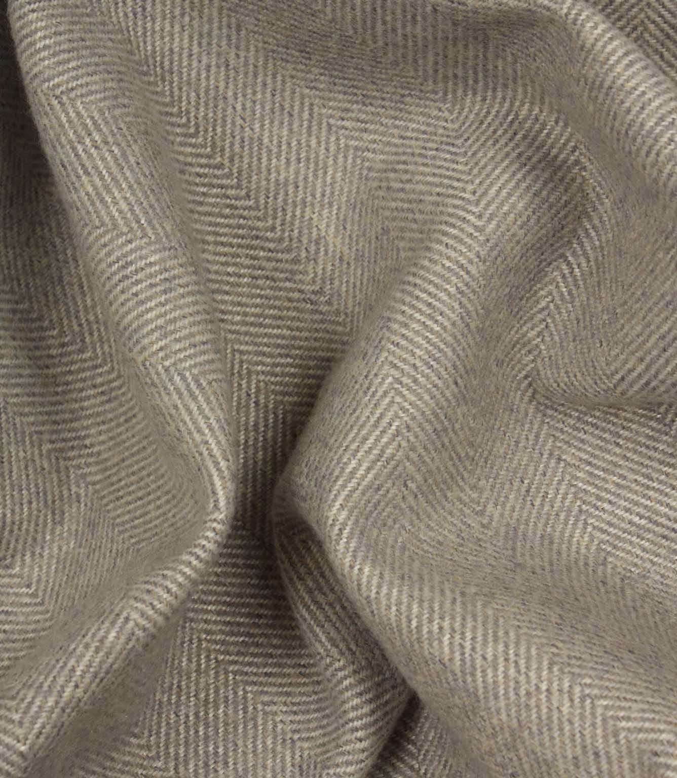 Close-up of grey fabric with a herringbone pattern
