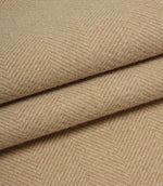 Close-up of beige herringbone fabric with a subtle pattern