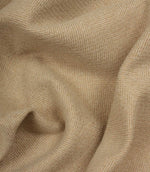 Close-up of beige fabric with a herringbone pattern
