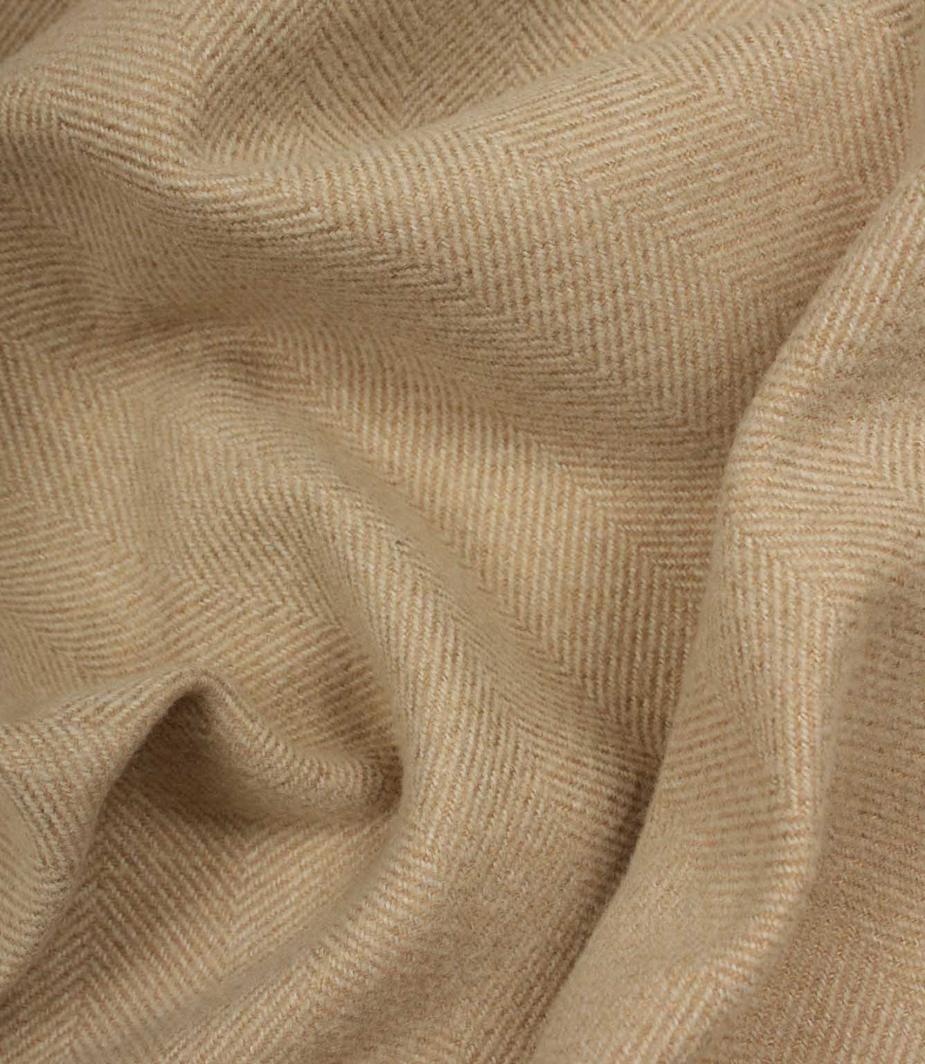 Close-up of beige fabric with a herringbone pattern
