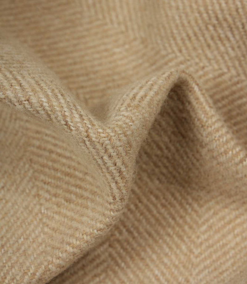 Close-up of beige fabric with a herringbone pattern