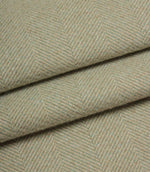 Close-up of herringbone patterned fabric in a light green colour.