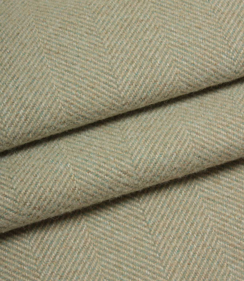 Close-up of herringbone patterned fabric in a light green colour.