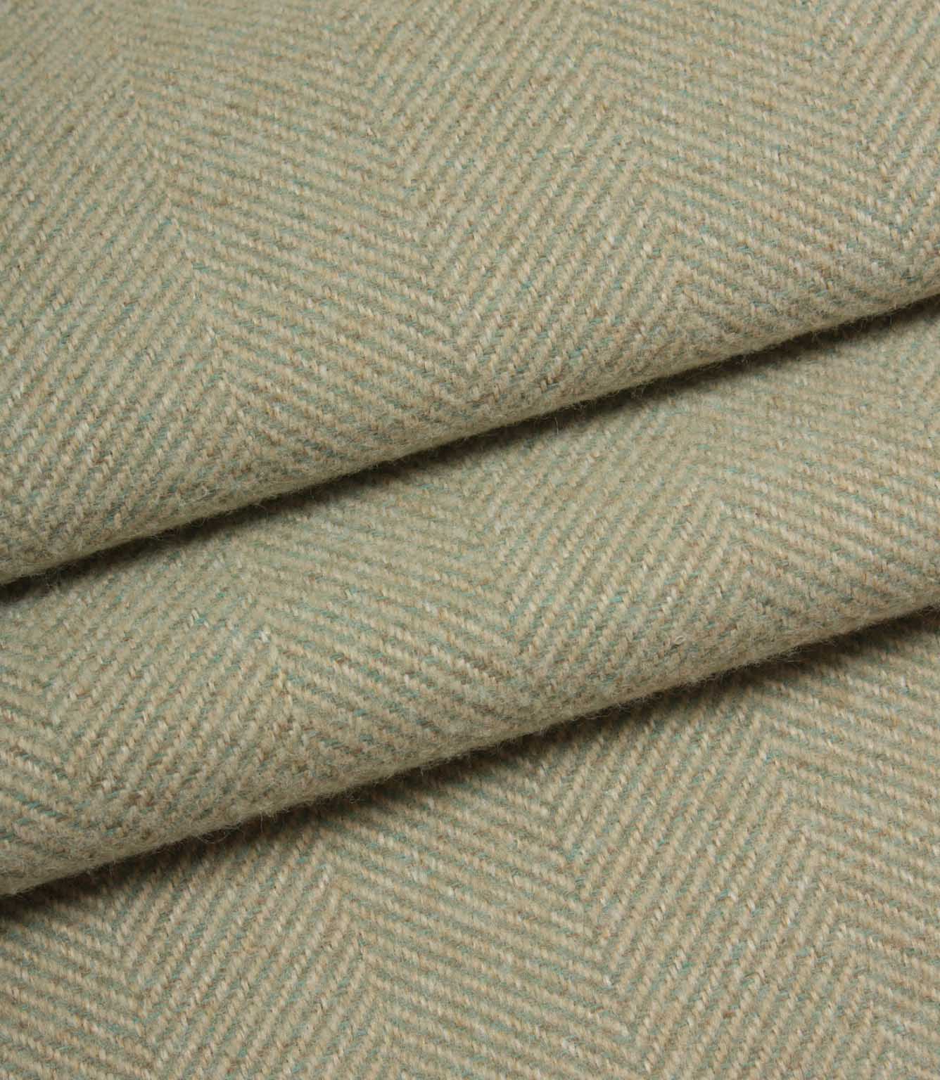 Close-up of herringbone patterned fabric in a light green colour.