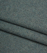 Close-up of textured blue fabric with a herringbone pattern