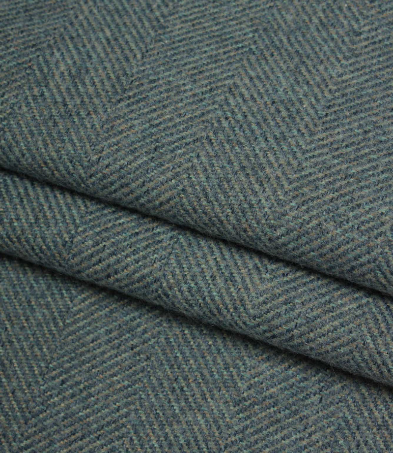 Close-up of textured blue fabric with a herringbone pattern