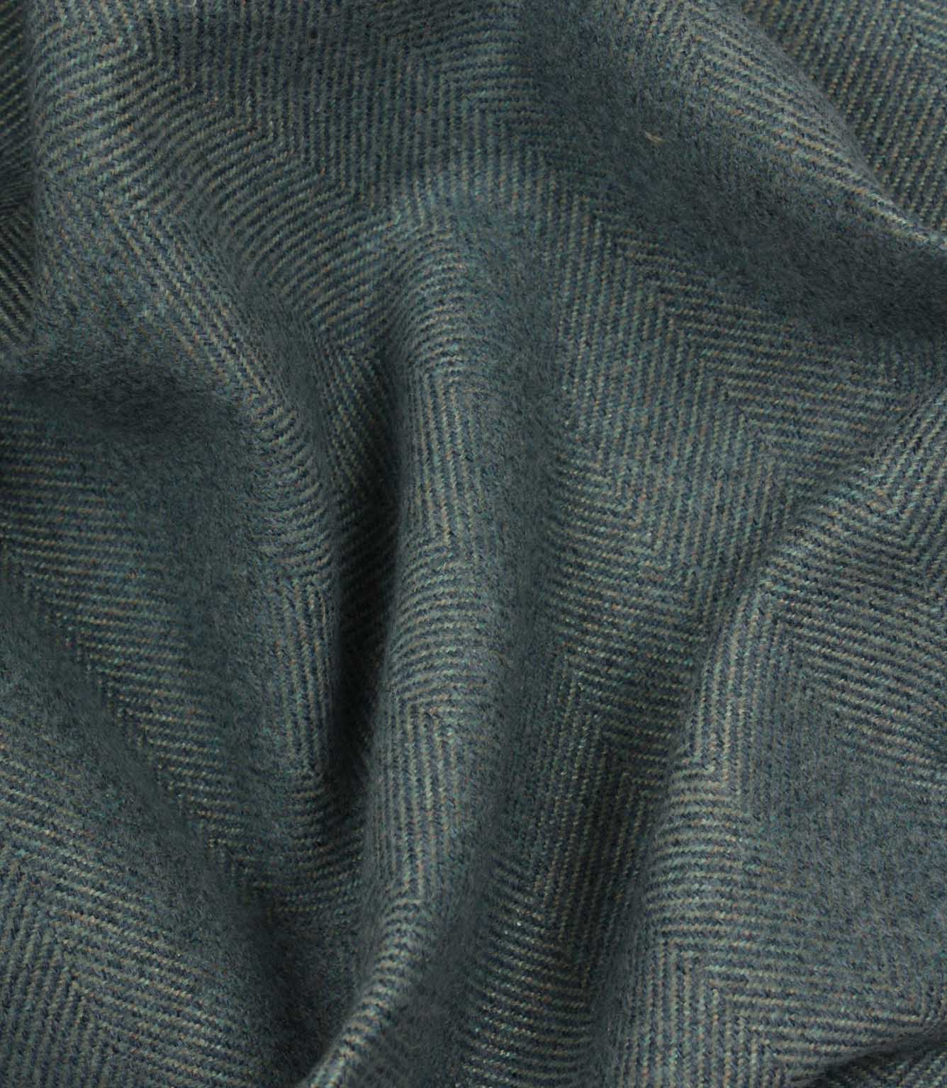 Close-up of textured blue fabric with a herringbone pattern