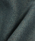 Close-up of textured blue fabric with a herringbone pattern