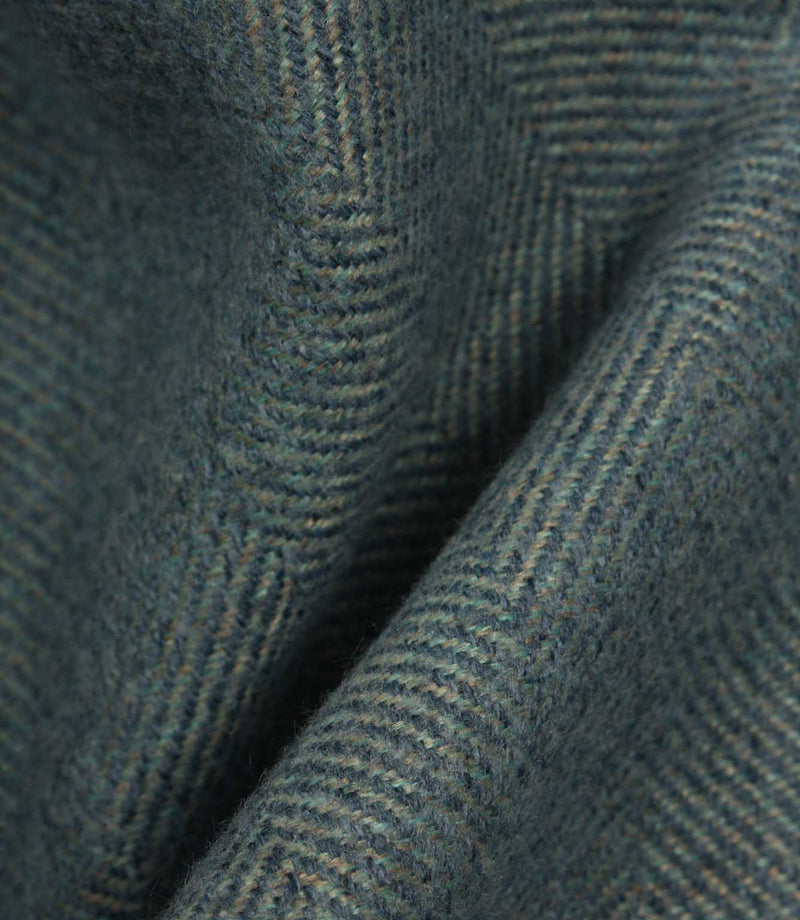Close-up of textured blue fabric with a herringbone pattern