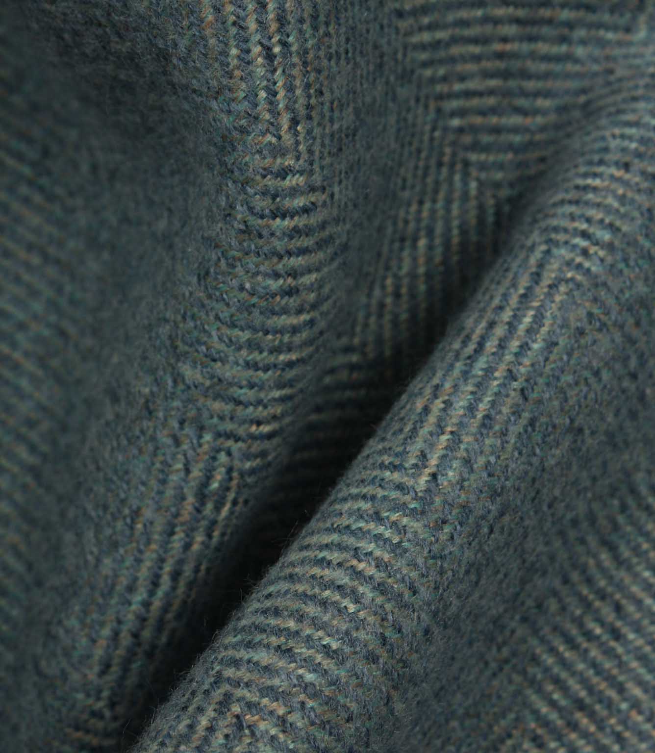 Close-up of textured blue fabric with a herringbone pattern