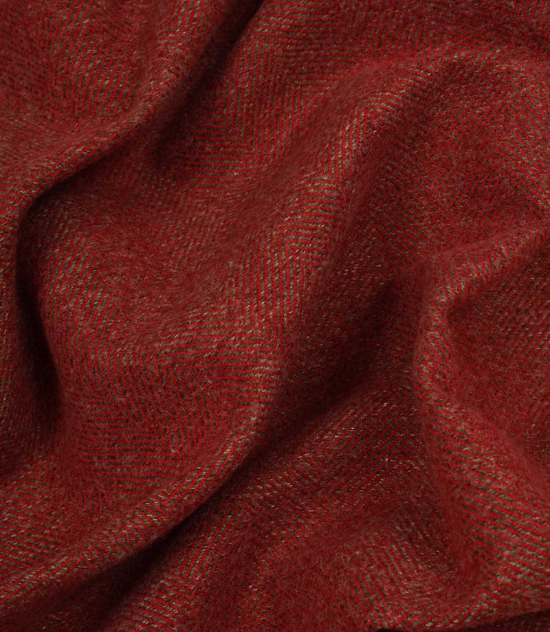 Close-up of red fabric with a textured herringbone pattern