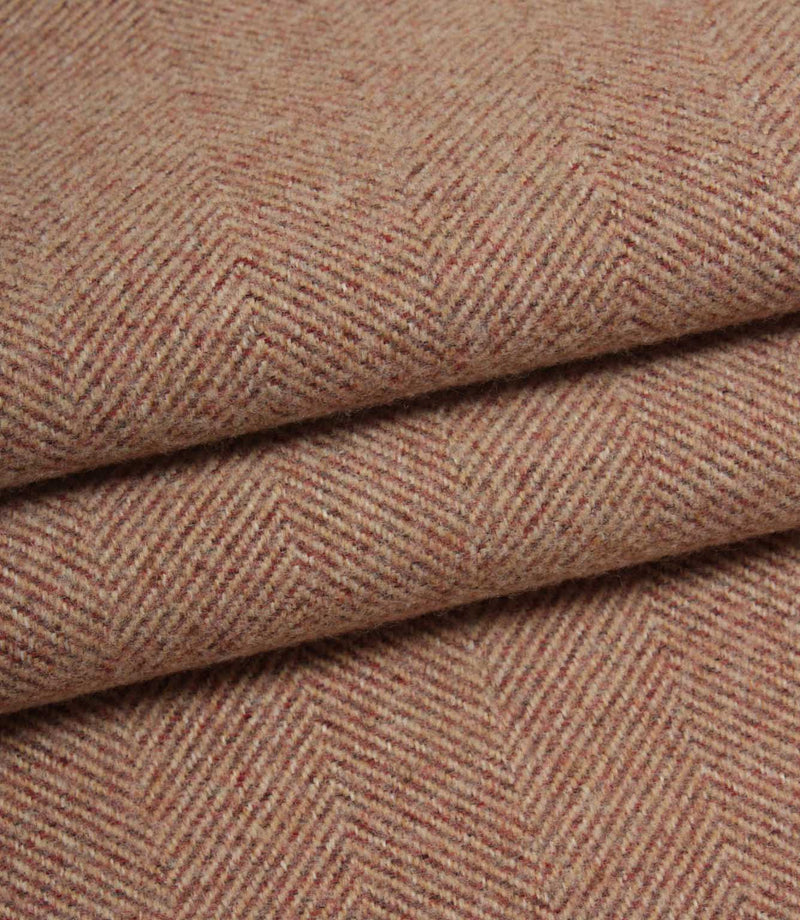 Close-up of rose herringbone fabric with a subtle pattern.