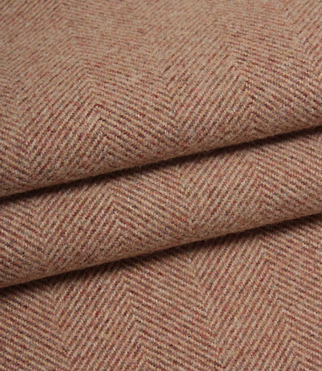 Close-up of rose herringbone fabric with a subtle pattern.