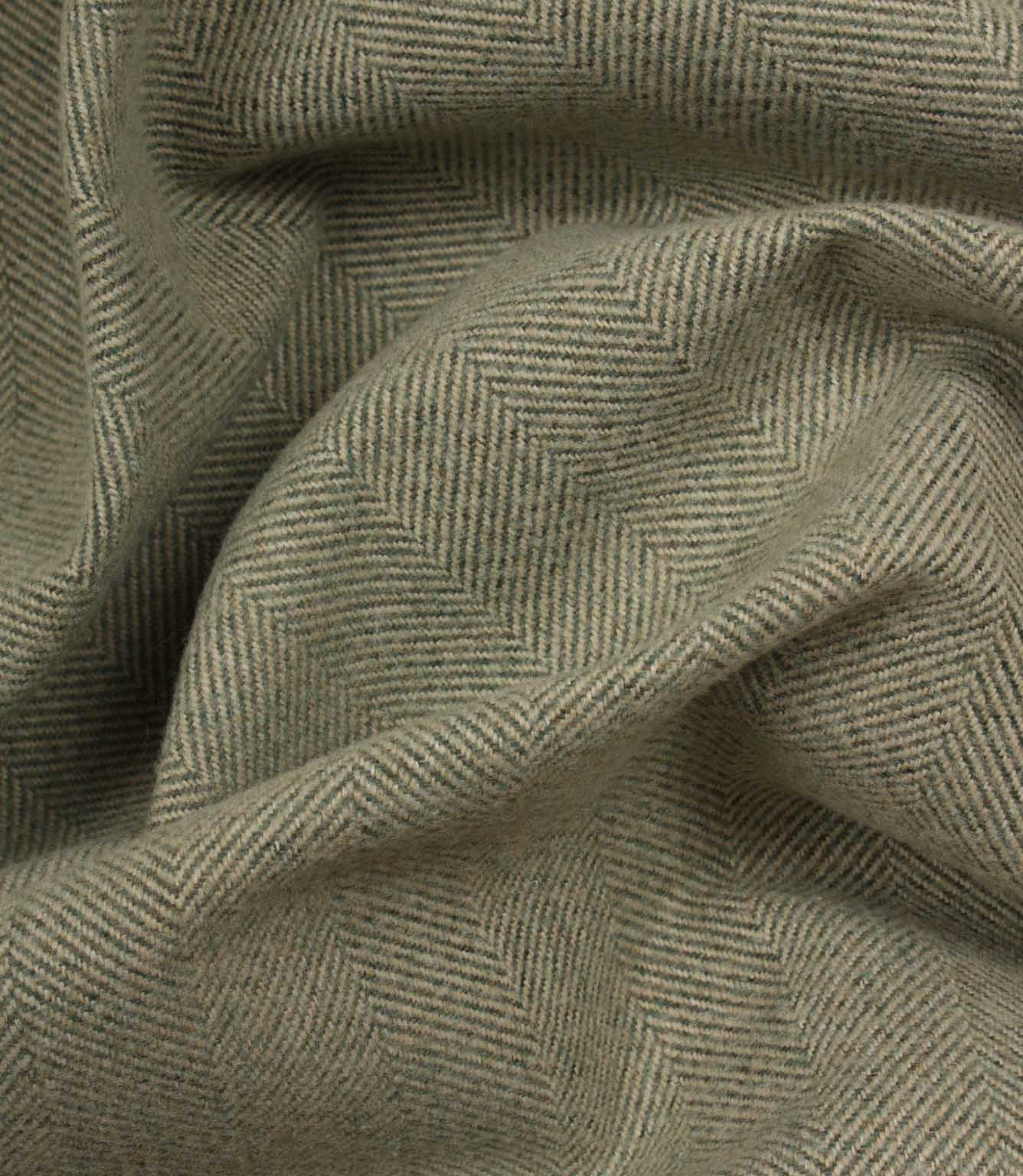 Close-up of green fabric with a herringbone pattern