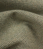 Close-up of textured green fabric with a herringbone pattern