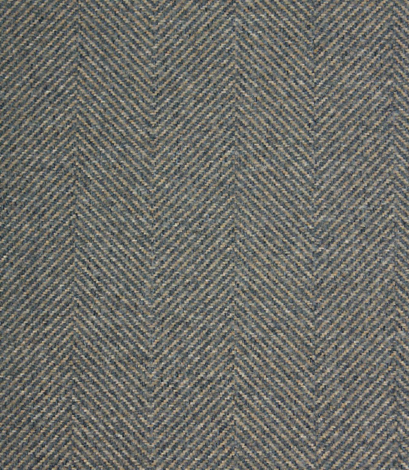 Textured fabric with a herringbone pattern in blue and beige tones.