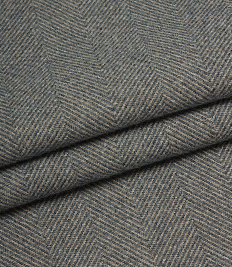 Close-up of herringbone patterned fabric in blue tones