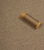Spool of thread on a textured fabric background