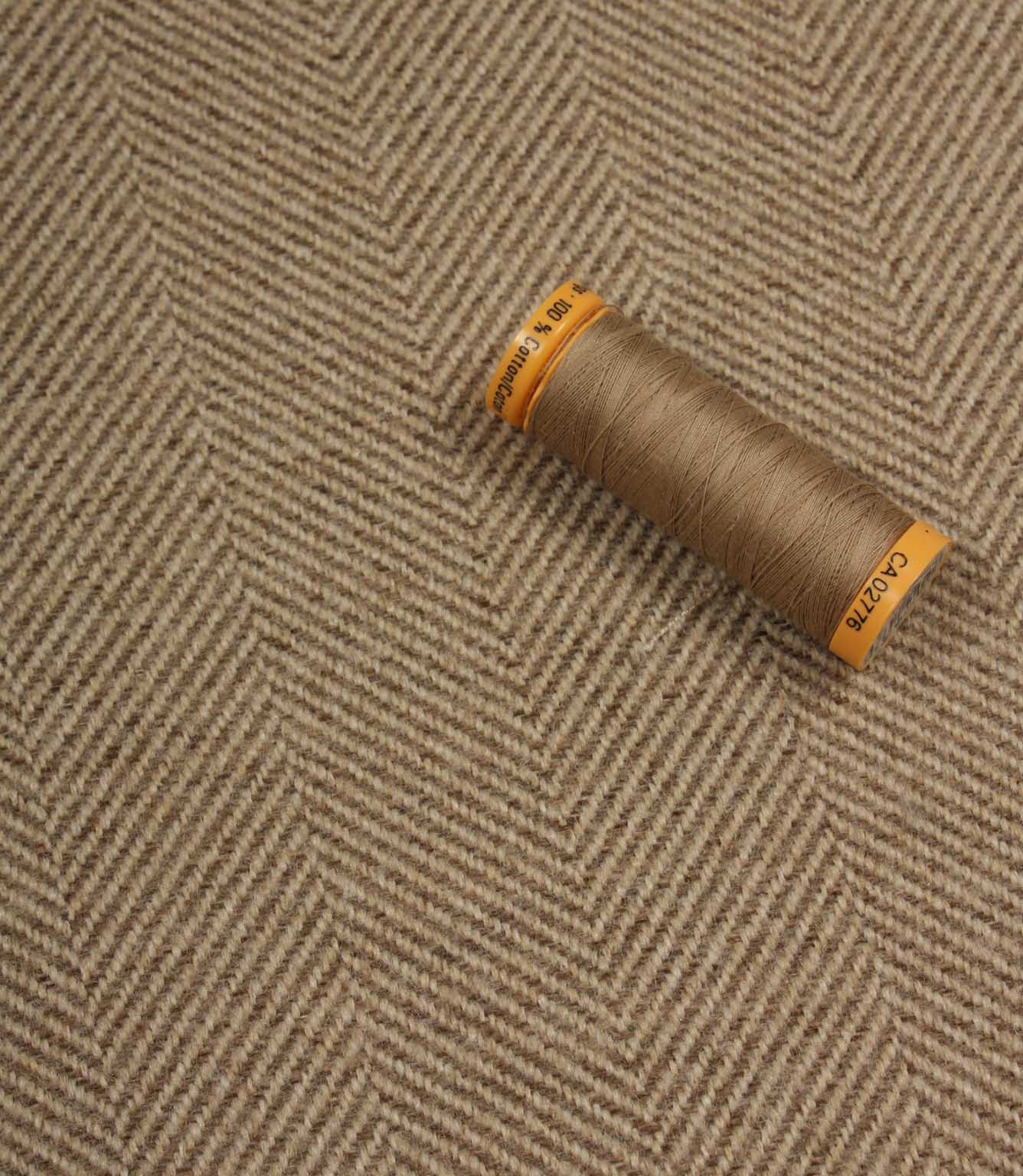 Spool of thread on a textured fabric background