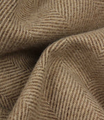 Close-up of brown fabric with a herringbone pattern