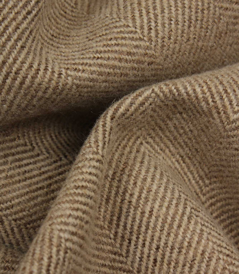 Close-up of brown fabric with a herringbone pattern