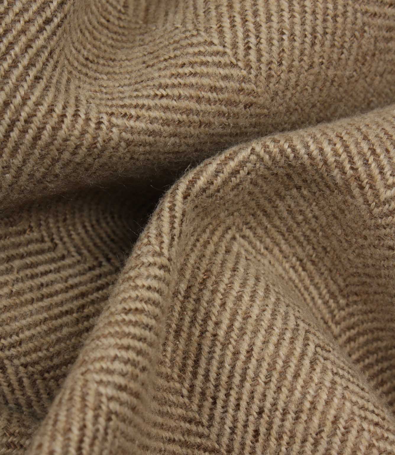 Close-up of brown fabric with a herringbone pattern