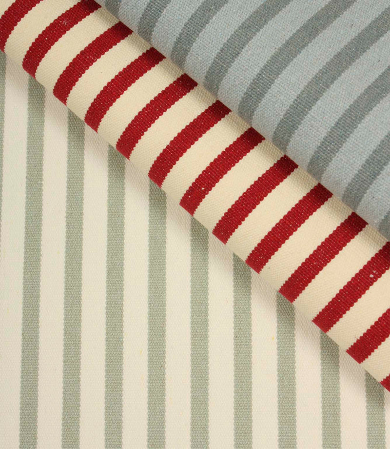 Fernley Stripe sage green striped upholstery fabric displayed alongside coordinating red and blue stripe fabrics, highlighting complementary woven stripe colourways.