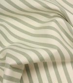 Draped Fernley Stripe woven upholstery fabric featuring soft sage green stripes on ivory, demonstrating the fabric’s natural movement and texture.