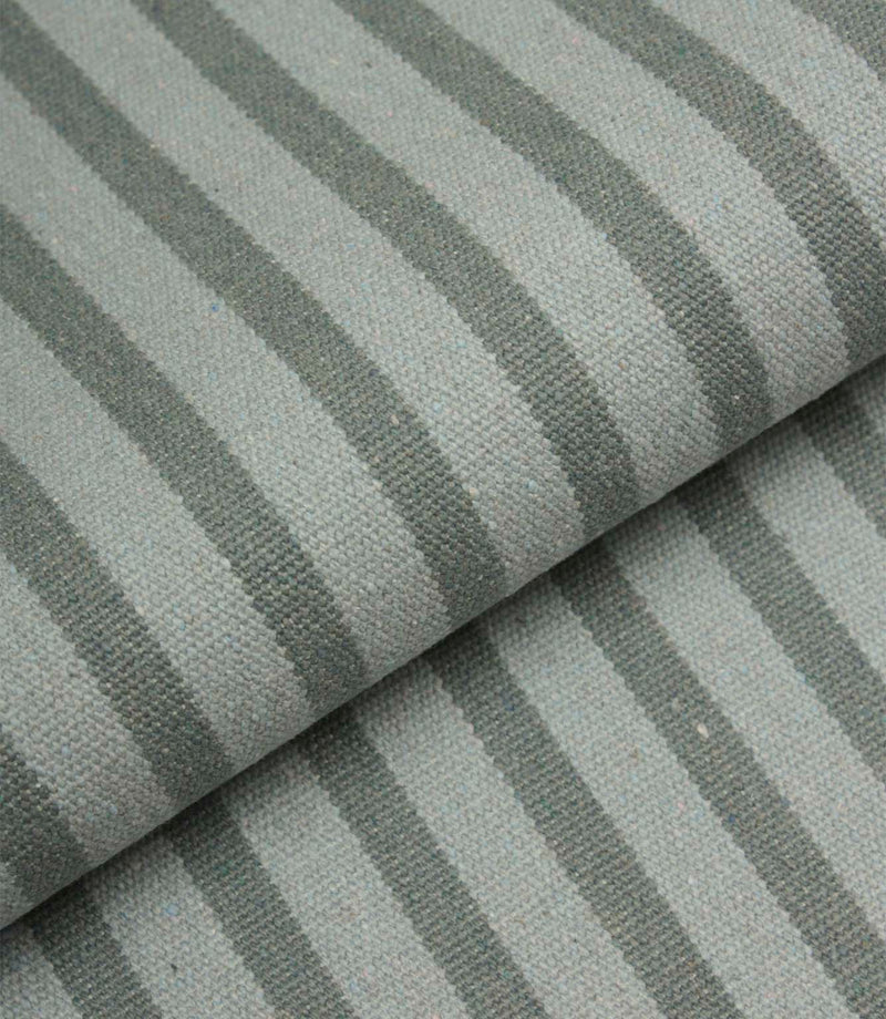 Folded Fernley Stripe upholstery fire retardant fabric showing steel blue vertical stripes and the fabric's substantial woven construction.