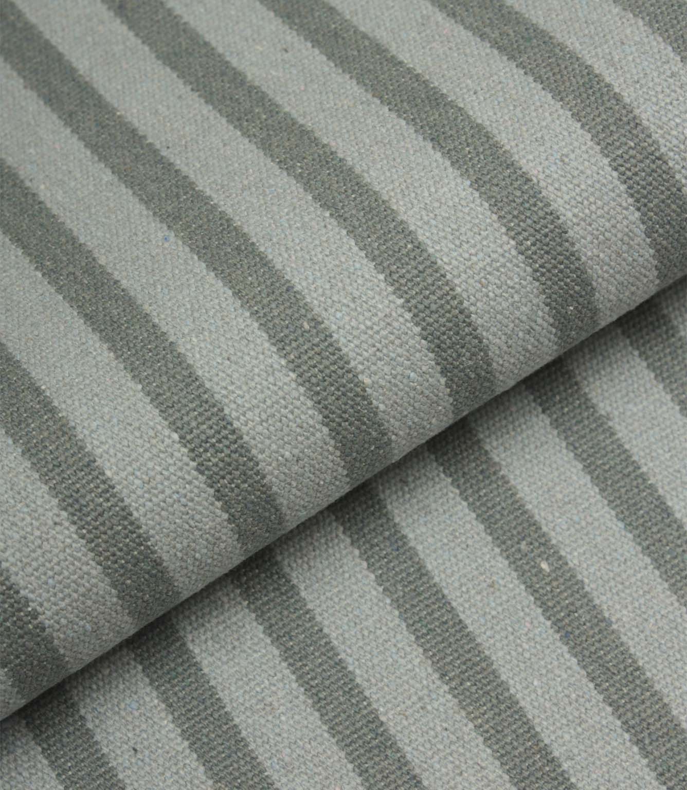 Folded Fernley Stripe upholstery fire retardant fabric showing steel blue vertical stripes and the fabric's substantial woven construction.
