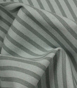Draped Fernley Stripe woven upholstery fabric featuring steel blue stripes on an ivory ground, demonstrating natural movement and texture.