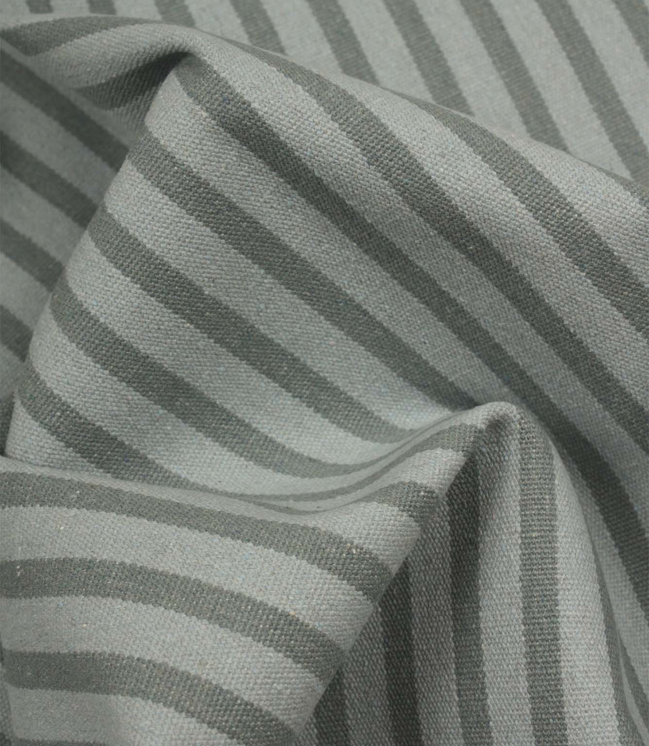 Draped Fernley Stripe woven upholstery fabric featuring steel blue stripes on an ivory ground, demonstrating natural movement and texture.