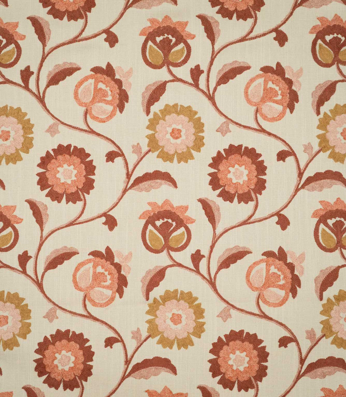 Foxmere Burnt Sienna fabric shown flat, featuring an embroidered trailing floral design on a warm natural cream ground, with stylised flowers, buds and curved leafy stems in burnt sienna, terracotta, soft blush pink and ochre tones.