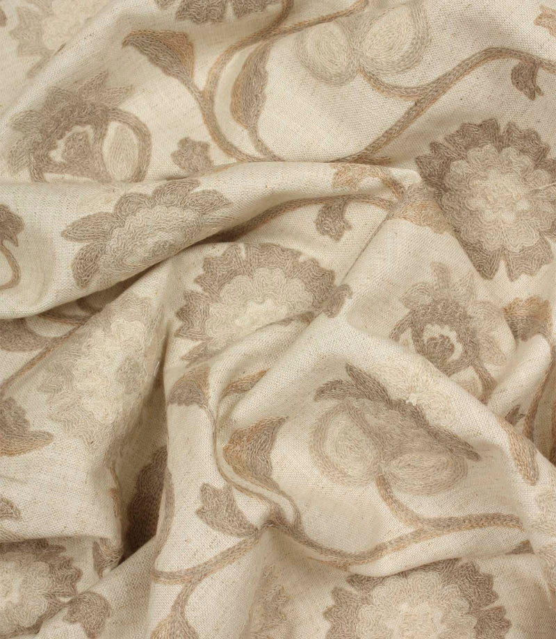 Draped Foxmere Natural fabric showing tonal embroidered flowers and flowing vine patterns in subtle neutral shades.