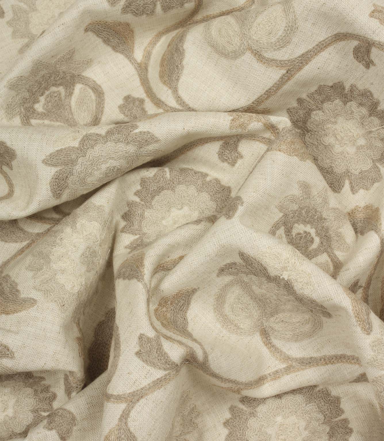 Draped Foxmere Natural fabric showing tonal embroidered flowers and flowing vine patterns in subtle neutral shades.