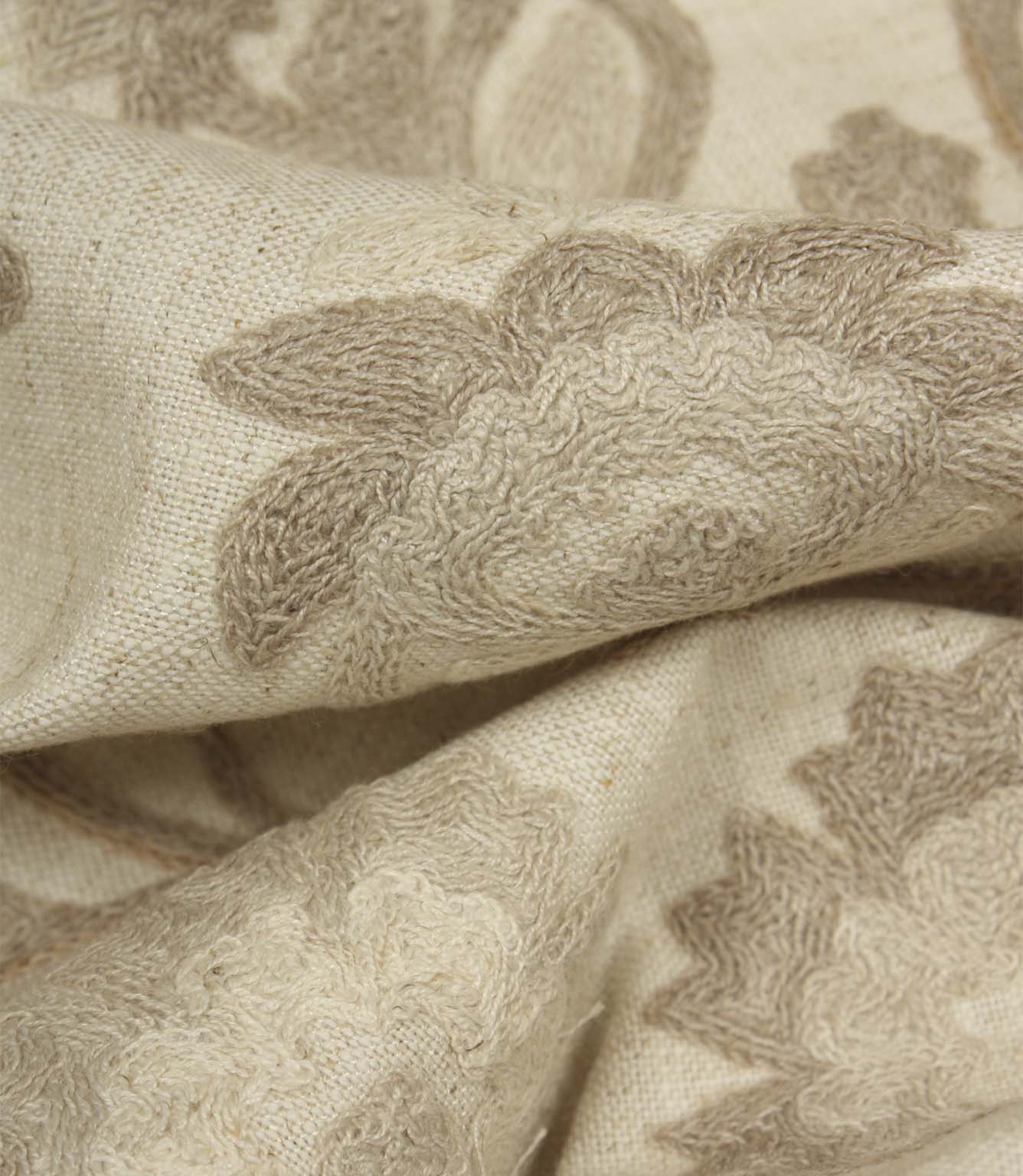 Detailed close-up of raised floral embroidery on Foxmere Natural fabric, showcasing texture and craftsmanship.