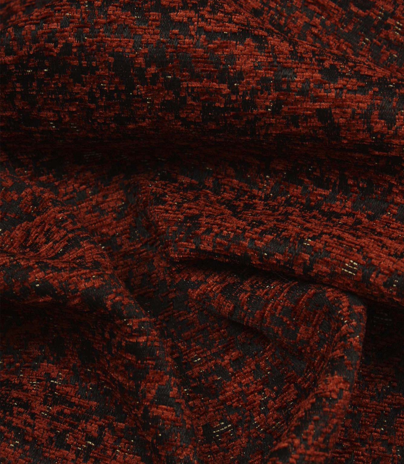 Draped Galaxy contemporary fabric demonstrating its luxurious handle and abstract woven pattern in copper and black colours.