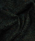 Draped Galaxy fabric in emerald green and black, showing the fabric’s soft handle, elegant folds and dimensional woven design.