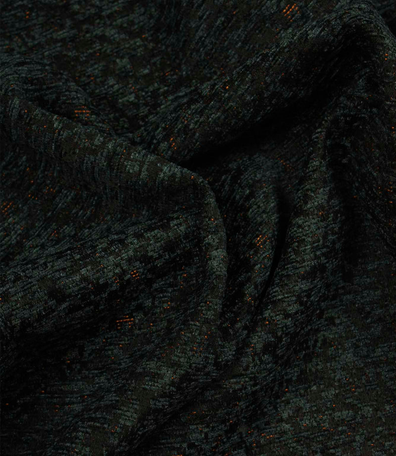Draped Galaxy fabric in emerald green and black, showing the fabric’s soft handle, elegant folds and dimensional woven design.