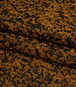 Folded Galaxy fabric in warm ochre tones displaying the intricate abstract weave and dimensional texture.