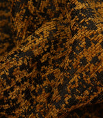 Detailed close-up of Galaxy upholstery fabric in ochre and black, revealing the tactile weave and subtle metallic detailing.