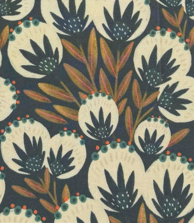 Close-up of Ember Crest outdoor fabric with layered foliage motifs in soft ivory, teal, burnt orange, and deep blue tones.