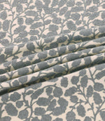 Gardiner Sandytan fabric featuring warm sandy brown textured leaf motifs and delicate embroidered branches on a natural cream background.