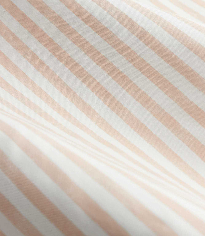 Close-up detail of blush pink and cream striped curtain fabric arranged in soft folds, showing the fine woven texture and evenly spaced vertical stripe design.